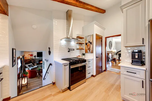a kitchen with stainless steel appliances granite countertop a stove and a refrigerator