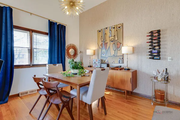 a view of a dining room with furniture and chandelier