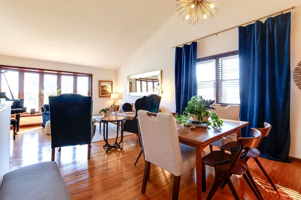 a dining room with furniture and wooden floor