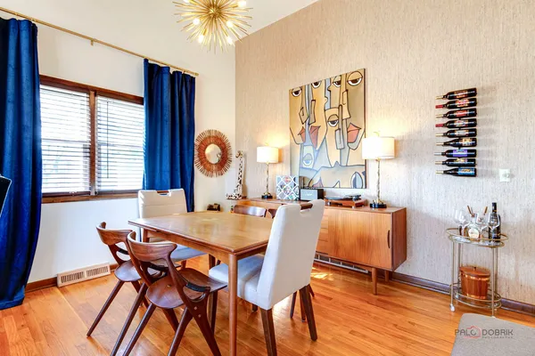 a view of a dining room with furniture and chandelier
