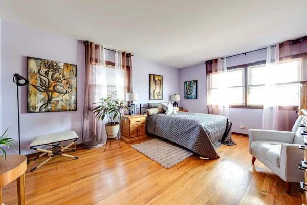 a spacious bedroom with a bed a couch and a window