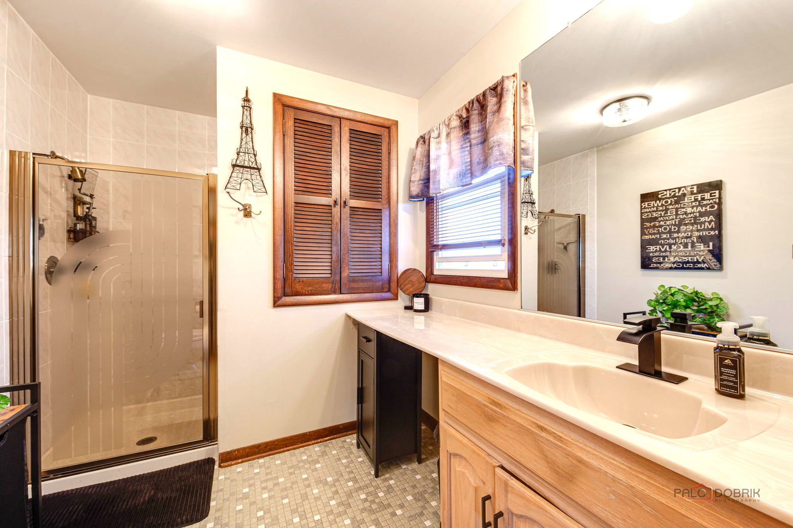 2042 South Goebbert Road Arlington Heights, IL 60005 - Photo 24 of 34 a bathroom with a granite countertop sink mirror and shower