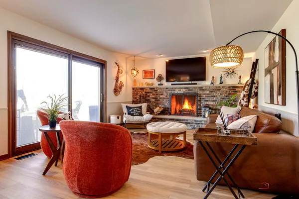 a living room with furniture a flat screen tv and a fireplace
