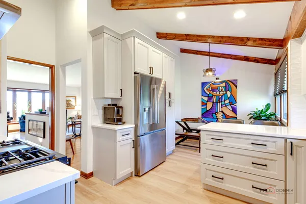 a kitchen with stainless steel appliances a refrigerator and a stove