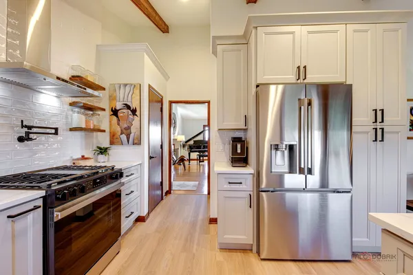 a kitchen with stainless steel appliances a refrigerator a stove and a sink
