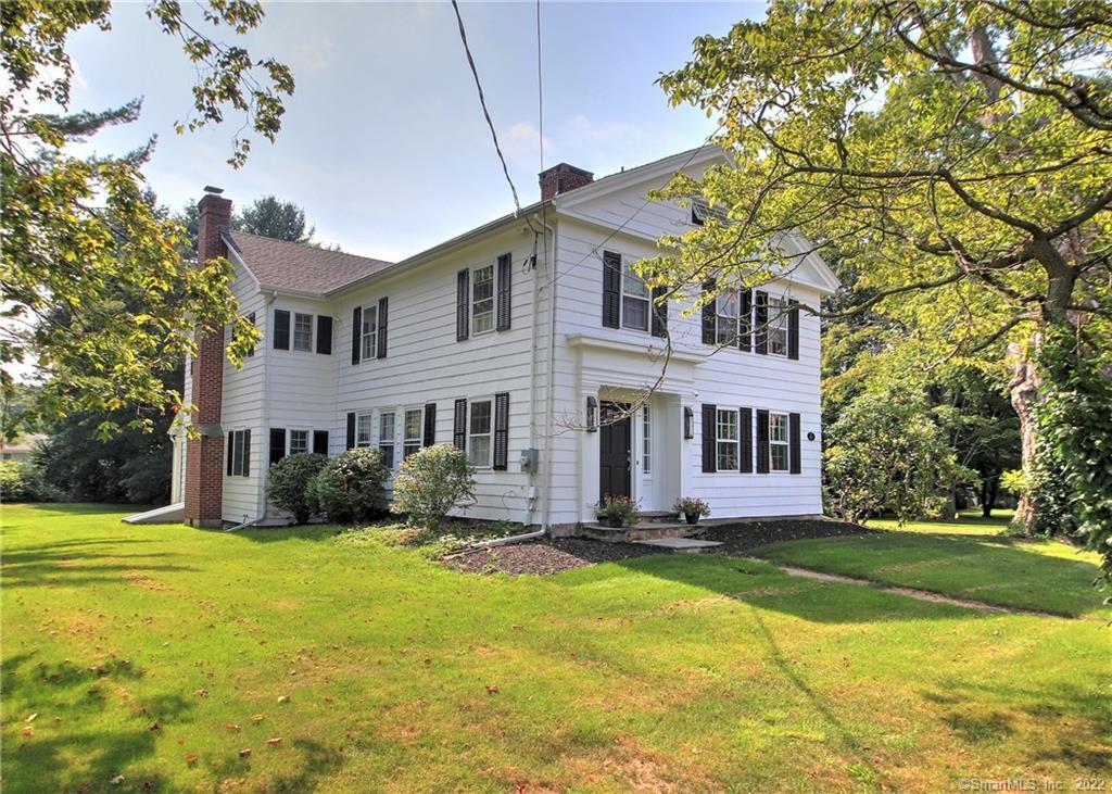 562 Orange Center Road Orange, CT 06477 - Photo 1 of 1 a front view of house with yard and green space