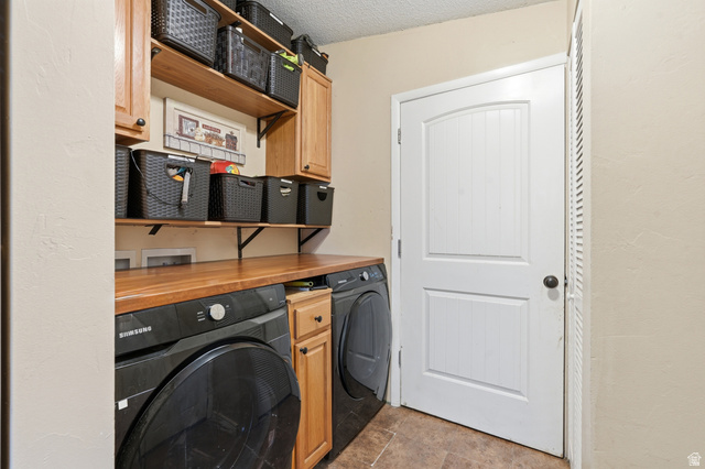 8066 North Valley View Heights Preston, ID 83263 - Photo 25 of 34 Dedicated laundry area featuring a wood-finish countertop, upper and lower wood cabinetry, and a pantry with a louvered door