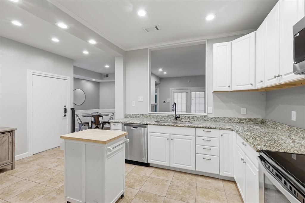 14277 Preston Road, Unit 615 Dallas, TX 75254 - Photo 8 of 20 a kitchen with sink stove and cabinets