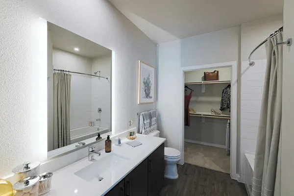 a bathroom with a double vanity sink mirror and refrigerator