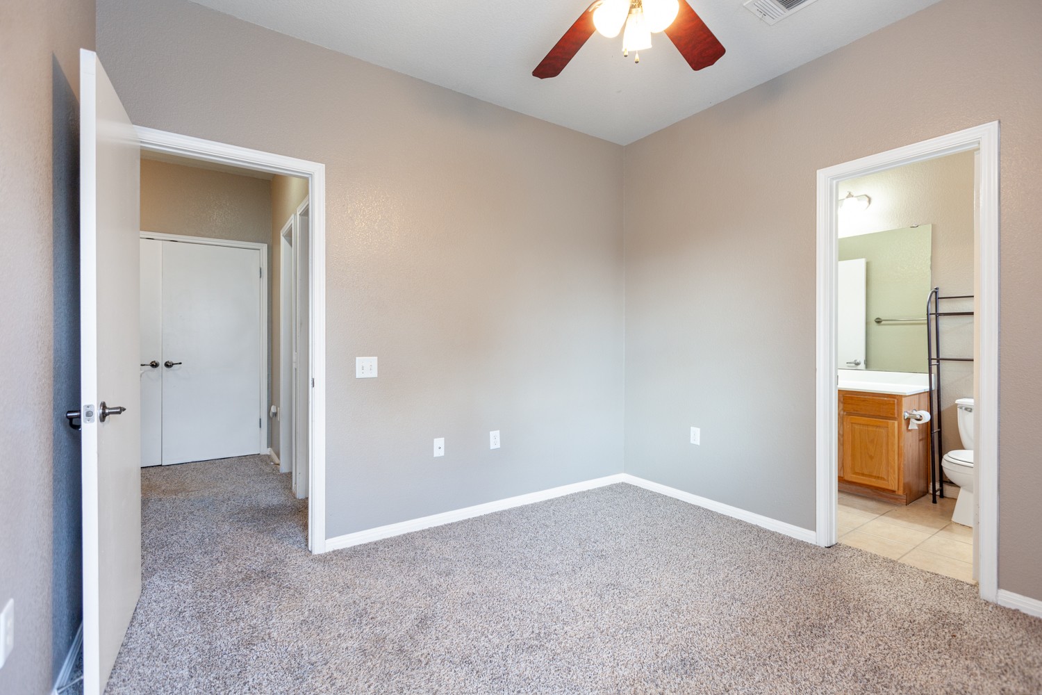 2326 Webberville Road, Unit B Austin, TX 78702 - Photo 14 of 15 Carpeted room featuring neutral-toned walls, a ceiling fan, and white baseboards