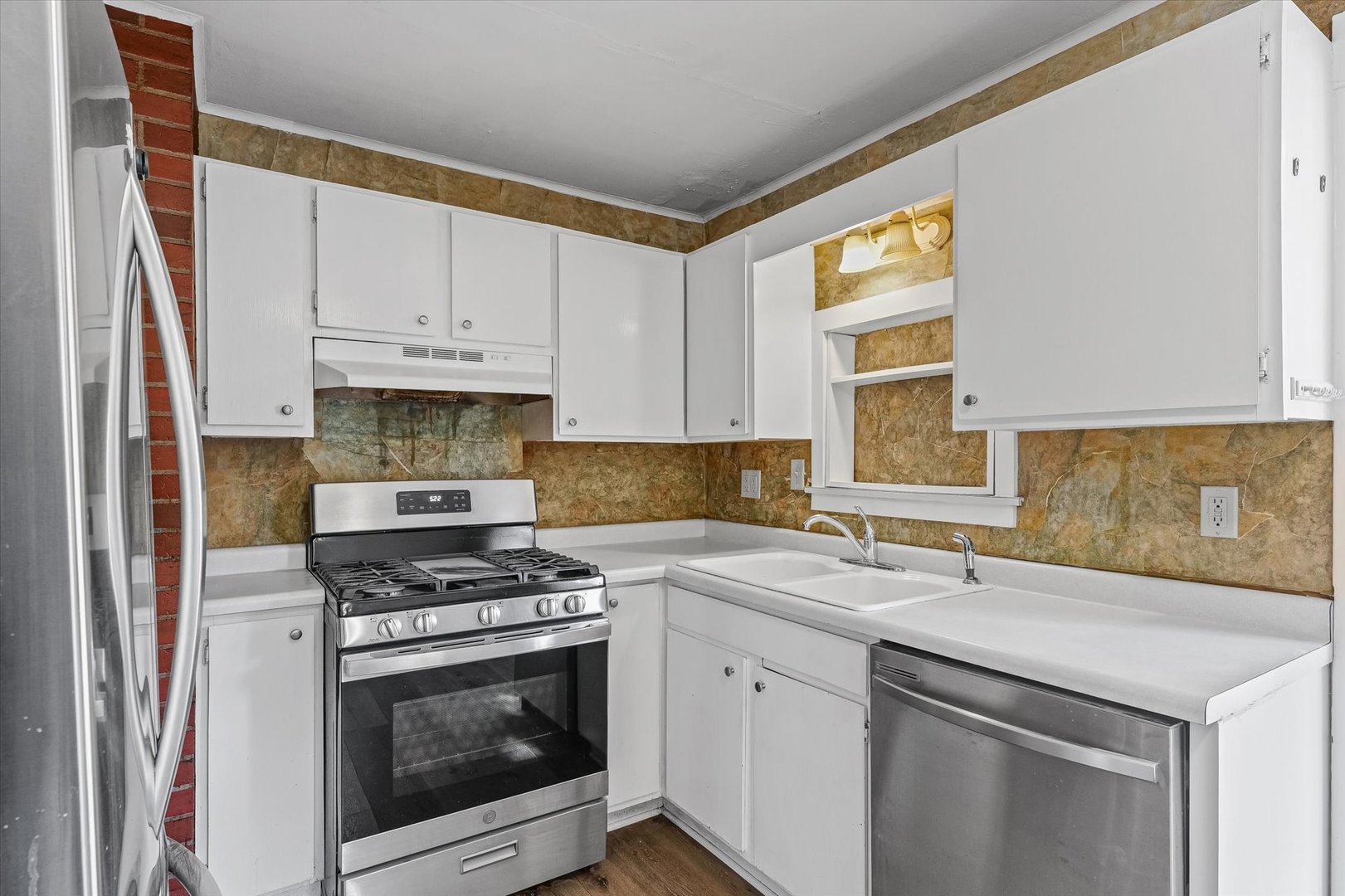 208 South Poplar Street Urbana, IL 61802 - Photo 11 of 30 a kitchen with stainless steel appliances granite countertop a sink stove and white cabinets