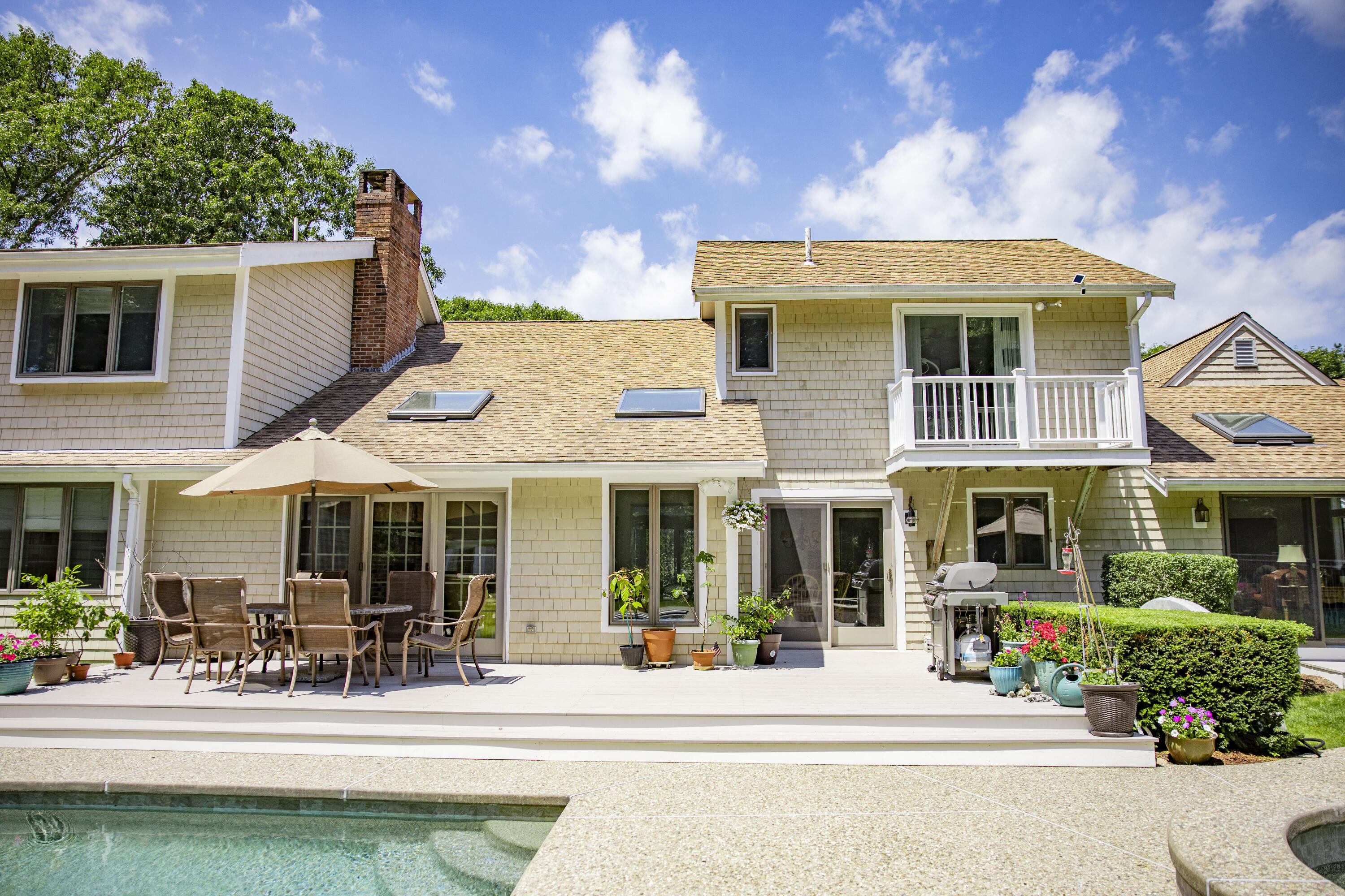 98 Bunker Hill Road Osterville, MA 02655 - Photo 66 of 88 a front view of a house with swimming pool and furniture