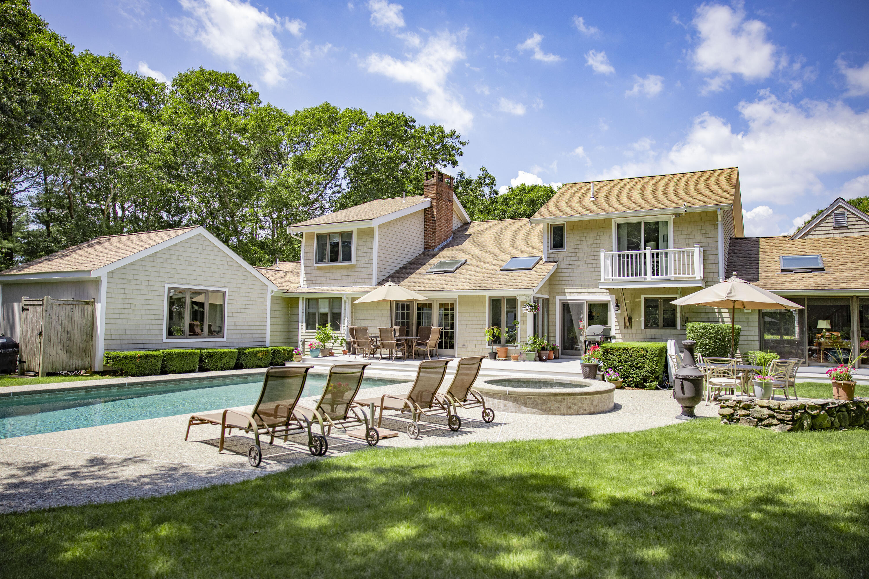 98 Bunker Hill Road Osterville, MA 02655 - Photo 70 of 88 a patio with a table and chairs and a yard