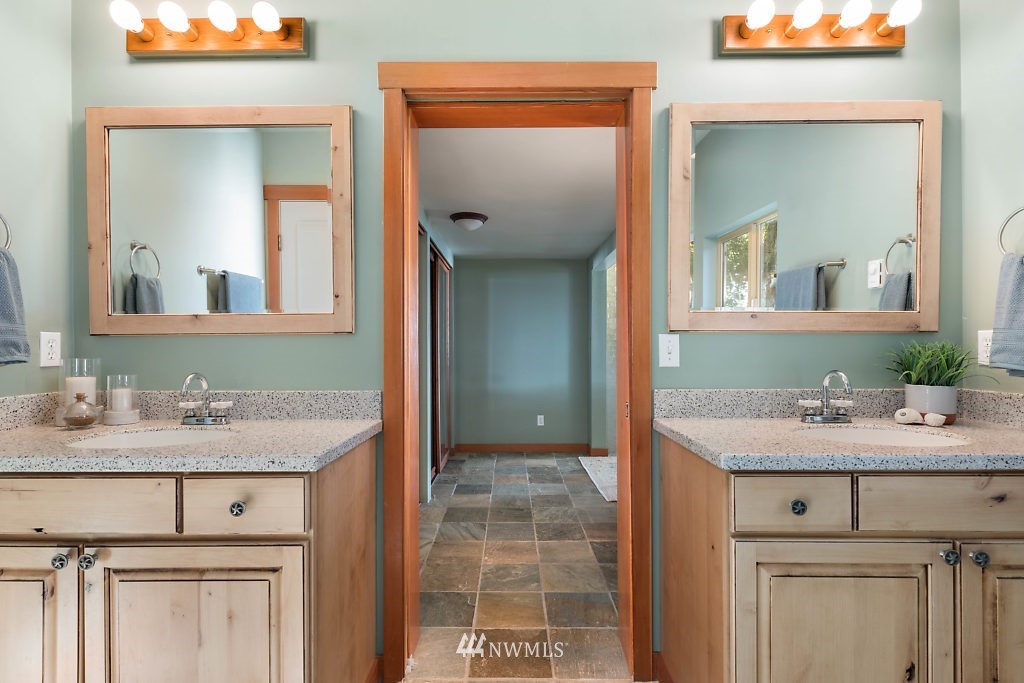 5036 Scurlock Road Freeland, WA 98249 - Photo 13 of 25 a bathroom with a granite countertop sink vanity and mirror