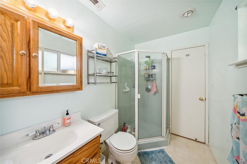 6791 Whispering Canyon Drive Anderson, CA 96007 - Photo 15 of 51 a bathroom with a sink a toilet and shower