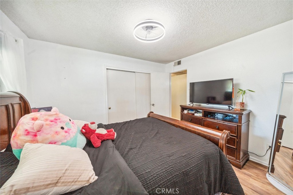 6791 Whispering Canyon Drive Anderson, CA 96007 - Photo 17 of 51 a bedroom with a bed and a flat screen tv