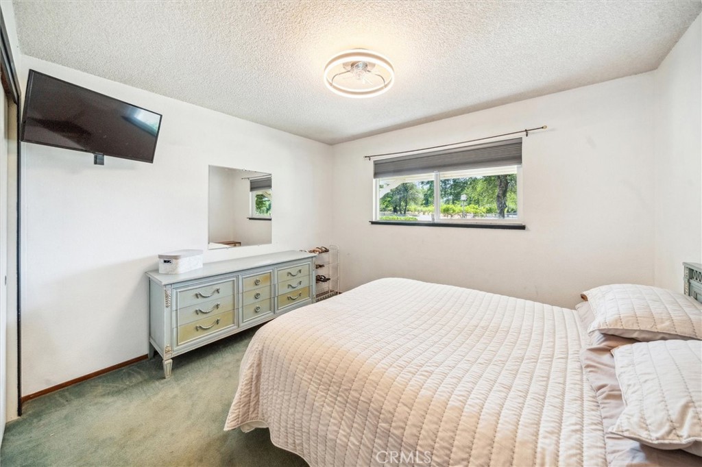 6791 Whispering Canyon Drive Anderson, CA 96007 - Photo 19 of 51 a bedroom with a bed and a window