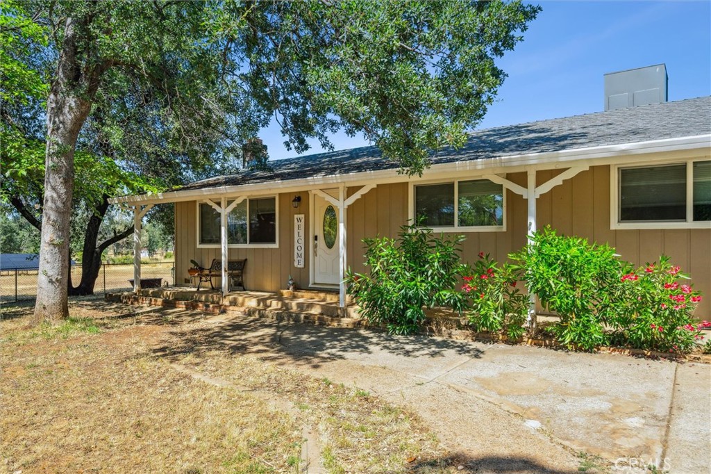 6791 Whispering Canyon Drive Anderson, CA 96007 - Photo 2 of 51 a front view of a house with a yard