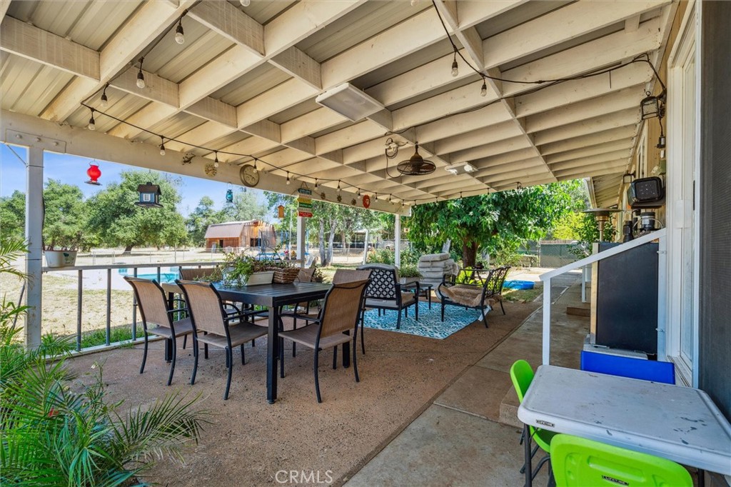 6791 Whispering Canyon Drive Anderson, CA 96007 - Photo 24 of 51 a view of a dinning table and chairs in the patio