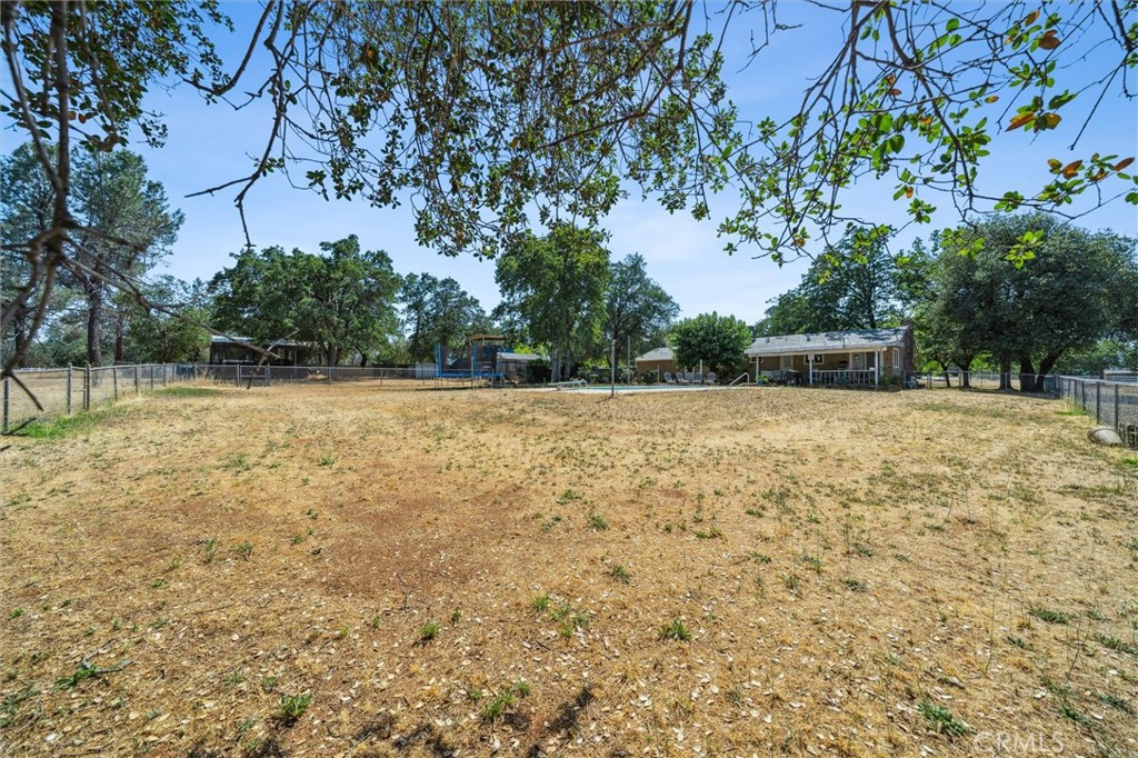 6791 Whispering Canyon Drive Anderson, CA 96007 - Photo 26 of 51 a view of a yard with a tree