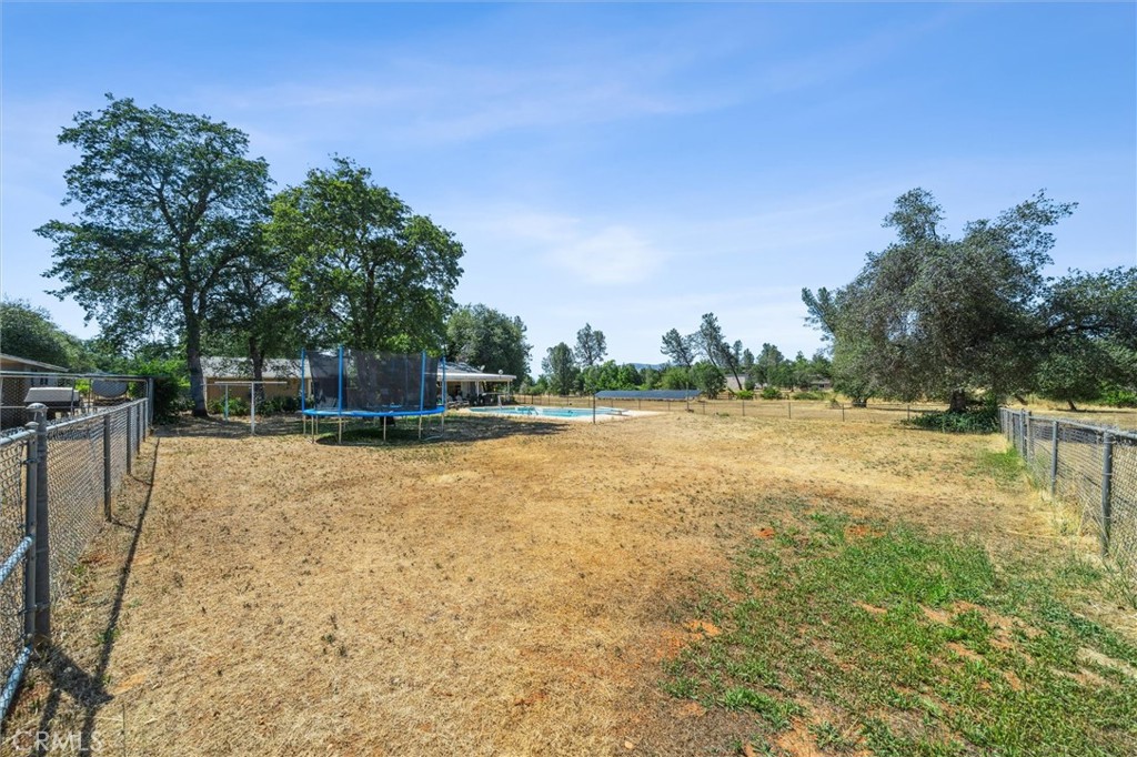 6791 Whispering Canyon Drive Anderson, CA 96007 - Photo 27 of 51 a view of a swimming pool with a yard