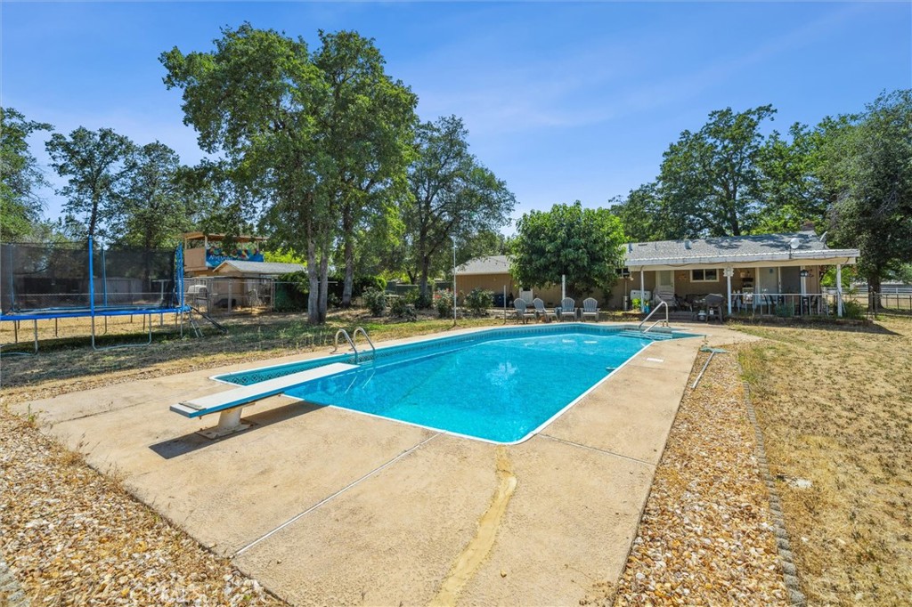 6791 Whispering Canyon Drive Anderson, CA 96007 - Photo 3 of 51 a view of a house with swimming pool and sitting area