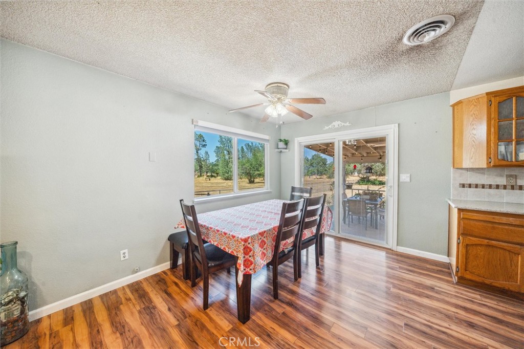 6791 Whispering Canyon Drive Anderson, CA 96007 - Photo 8 of 51 a dining room with furniture and wooden floor