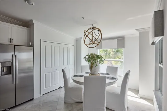a dining room with furniture potted plants and wooden floor