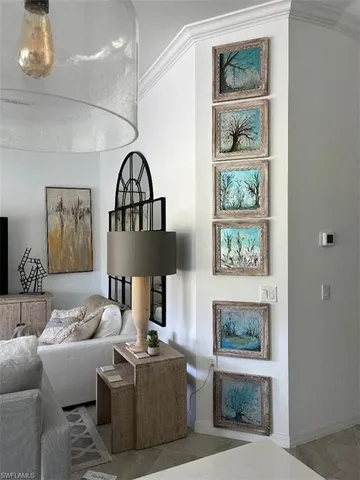 a living room with furniture and a painting on the wall
