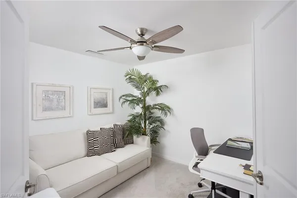 a living room with furniture and a potted plant