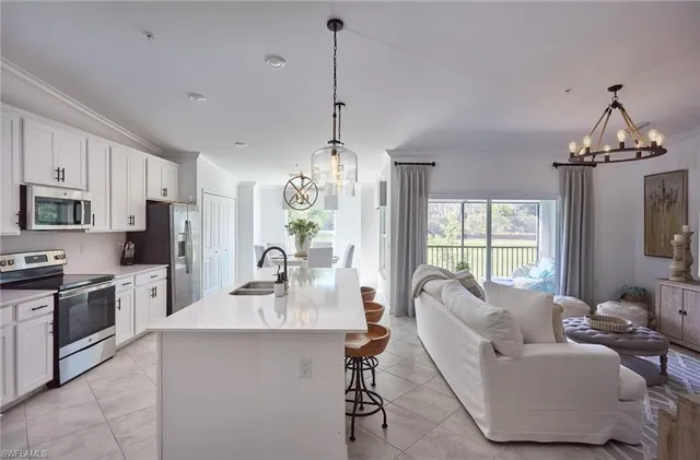 a dining room with furniture a chandelier and window