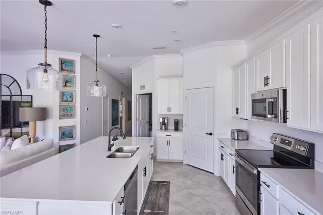 a kitchen with stainless steel appliances sink stove microwave and refrigerator