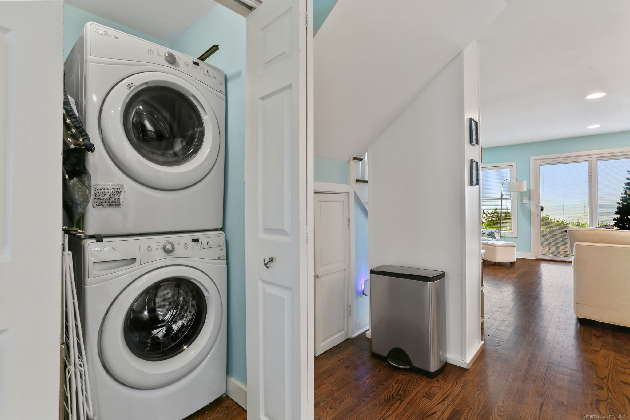 1235-1236 Fairfield Beach Road Fairfield, CT 06824 - Photo 11 of 39 a view of a hallway with washer and dryer