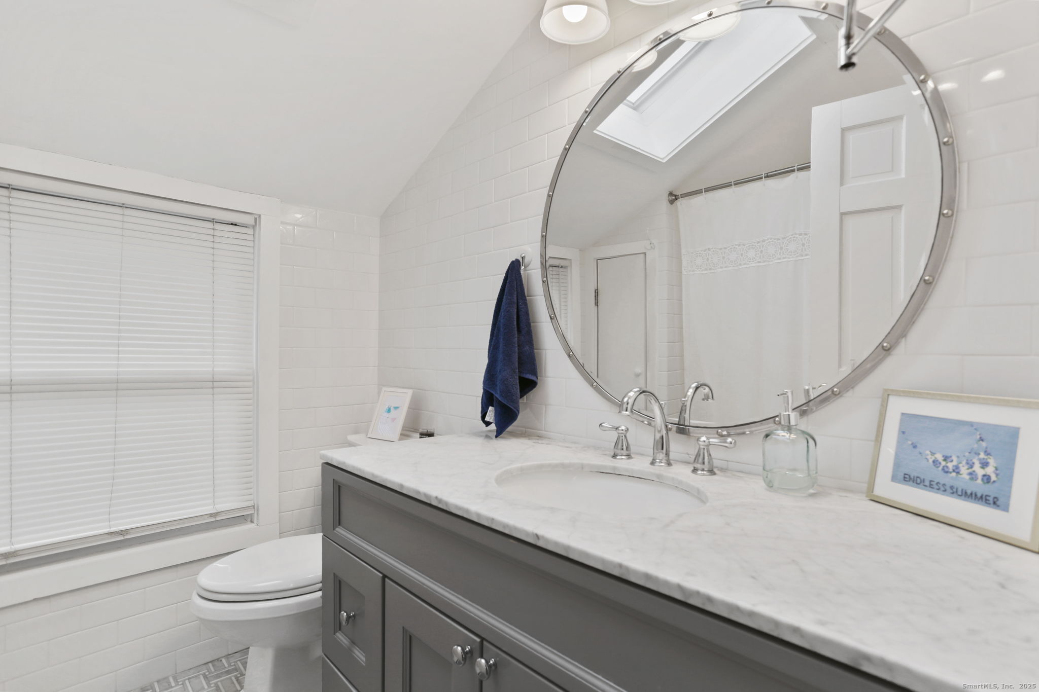 1235 Fairfield Beach Road Fairfield, CT 06824 - Photo 16 of 39 a bathroom with a granite countertop sink a toilet and a mirror