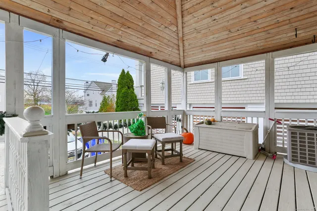 a balcony with furniture and wooden floor