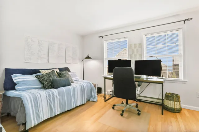 a bedroom with a bed potted plant with a large window