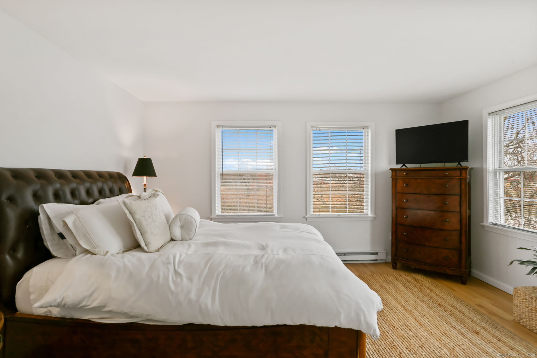 1235 Fairfield Beach Road Fairfield, CT 06824 - Photo 35 of 39 a bedroom with a bed and a flat tv screen on dresser