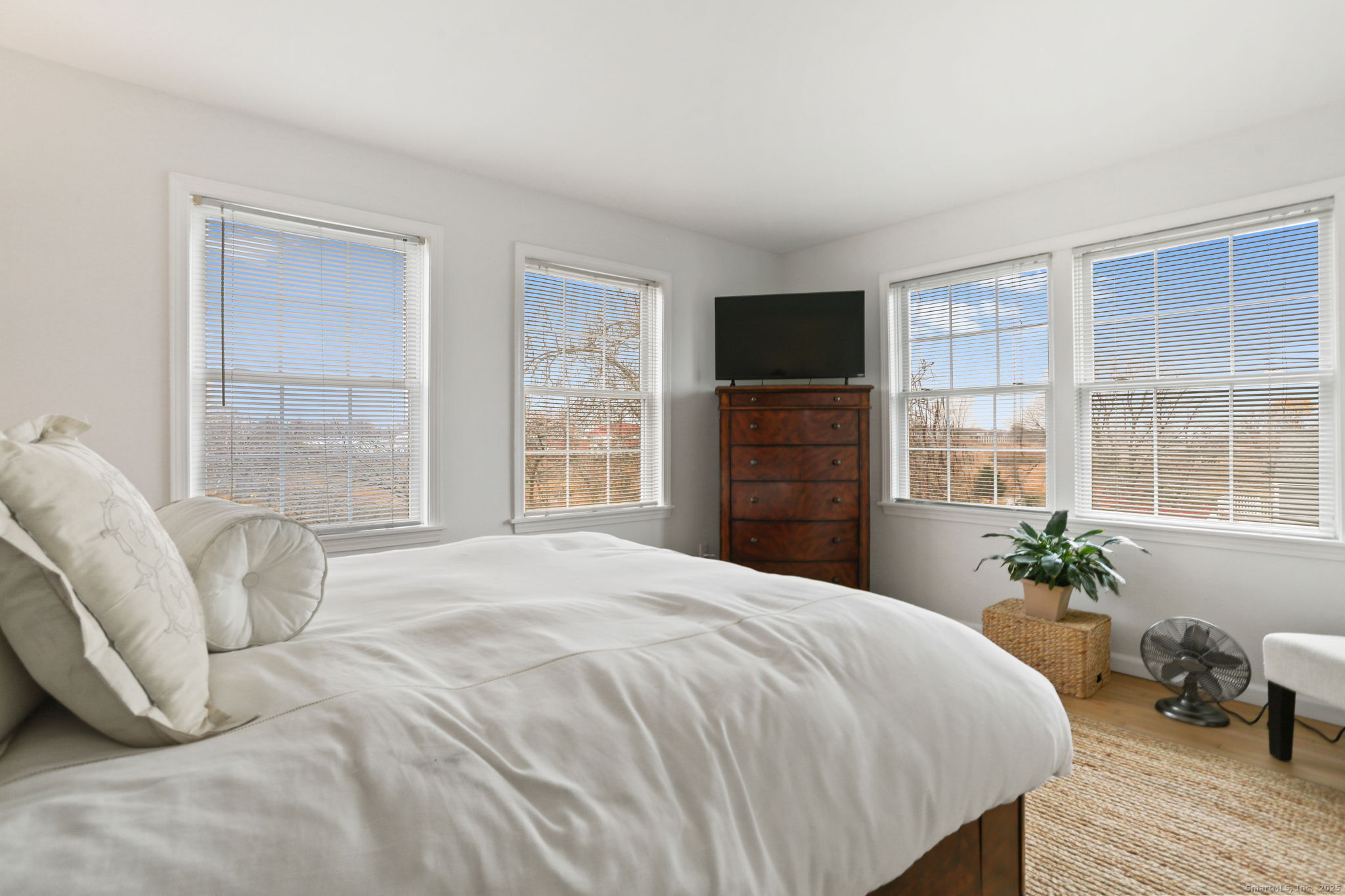1235 Fairfield Beach Road Fairfield, CT 06824 - Photo 36 of 39 a bedroom with a bed potted plant with a large window