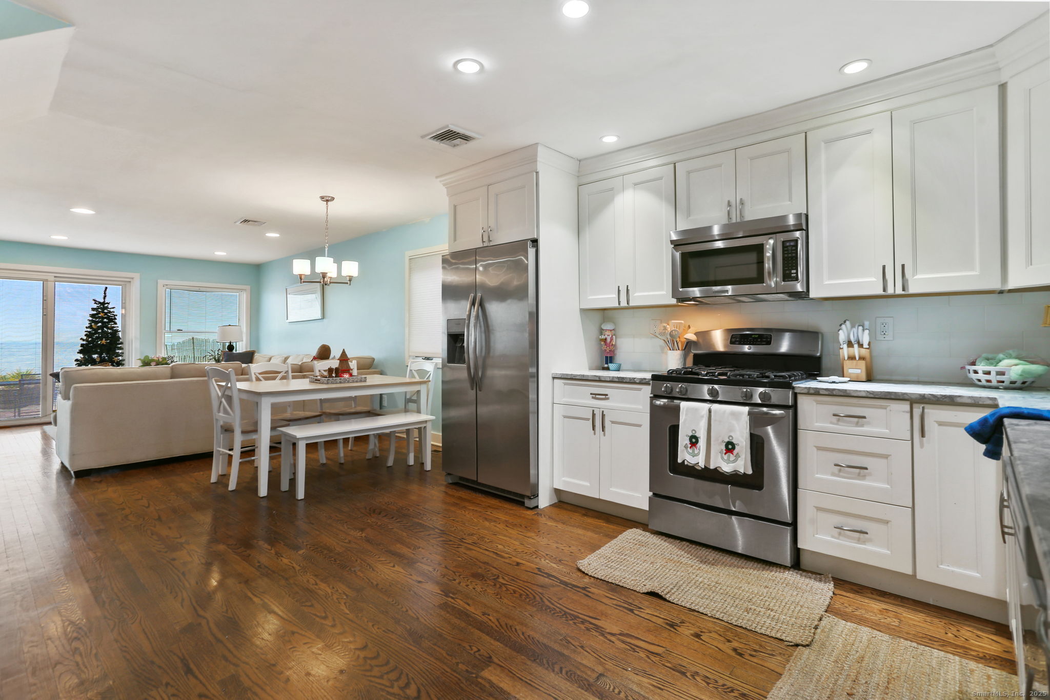 1235 Fairfield Beach Road Fairfield, CT 06824 - Photo 5 of 39 a kitchen with white cabinets and stainless steel appliances