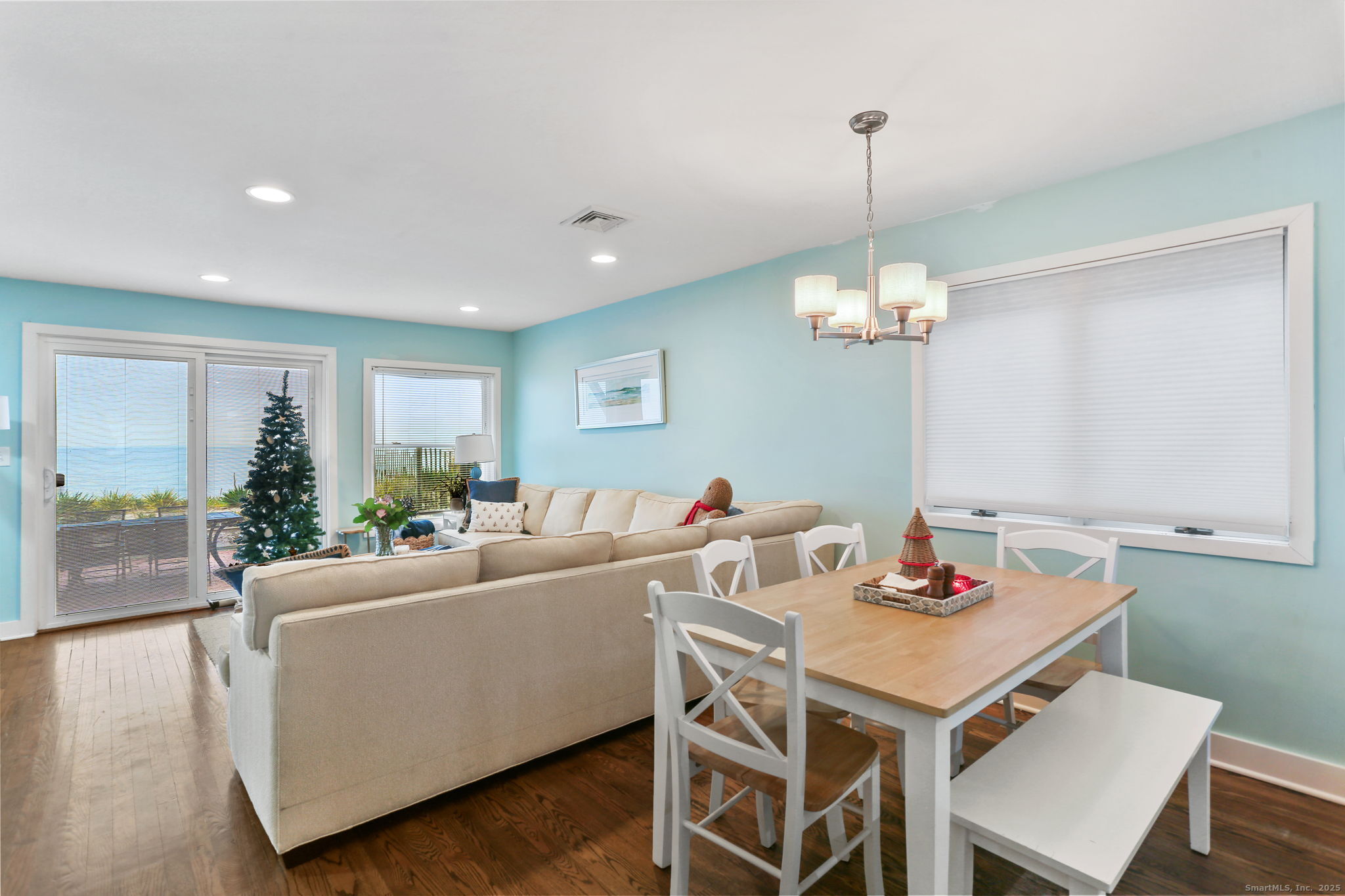 1235 Fairfield Beach Road Fairfield, CT 06824 - Photo 7 of 39 a living room with furniture a window and a chandelier