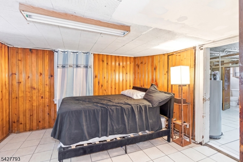 420 Mechanic Street Orange, NJ 07050 - Photo 10 of 18 a bedroom with a bed and a window