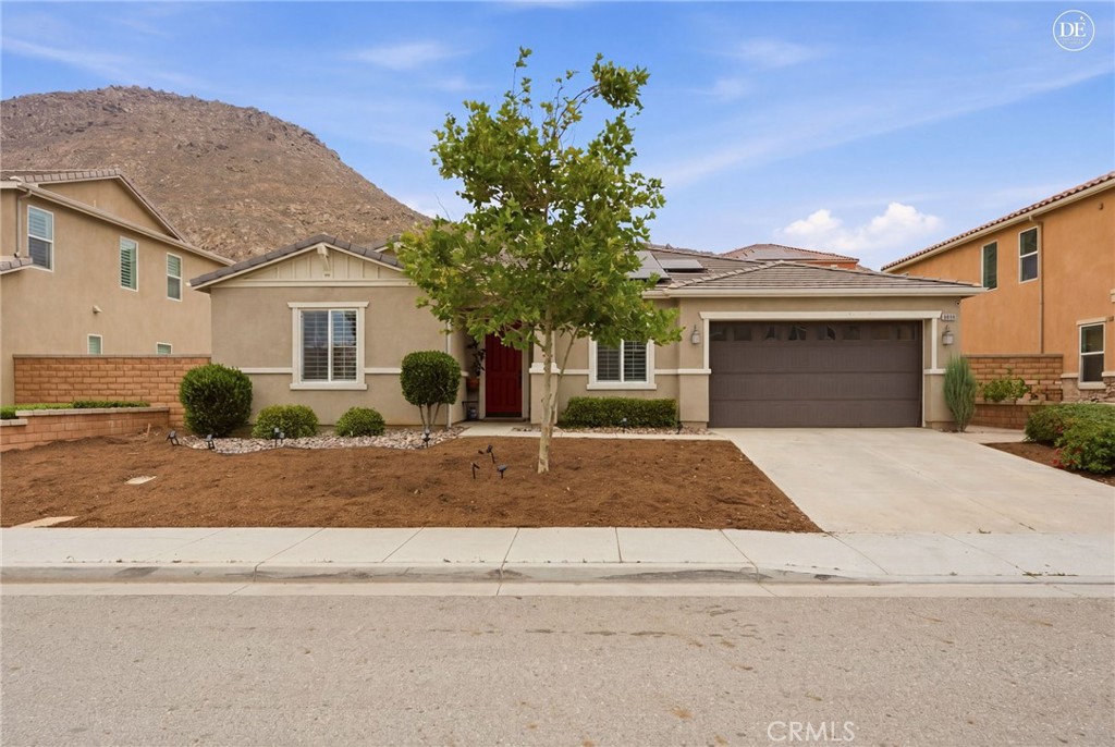 20948 Center Street Riverside, CA 92507 - Photo 4 of 92 a front view of a house with a yard and garage