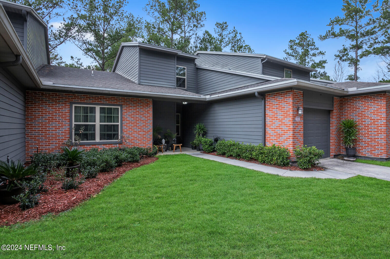 4190 Quiet Crk Loop Middleburg, FL 32068 - Photo 1 of 22 a front view of a house with a yard and potted plants