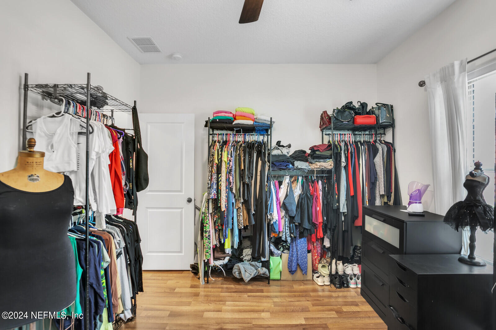 4190 Quiet Crk Loop Middleburg, FL 32068 - Photo 20 of 22 a view of walk in closet with clothes