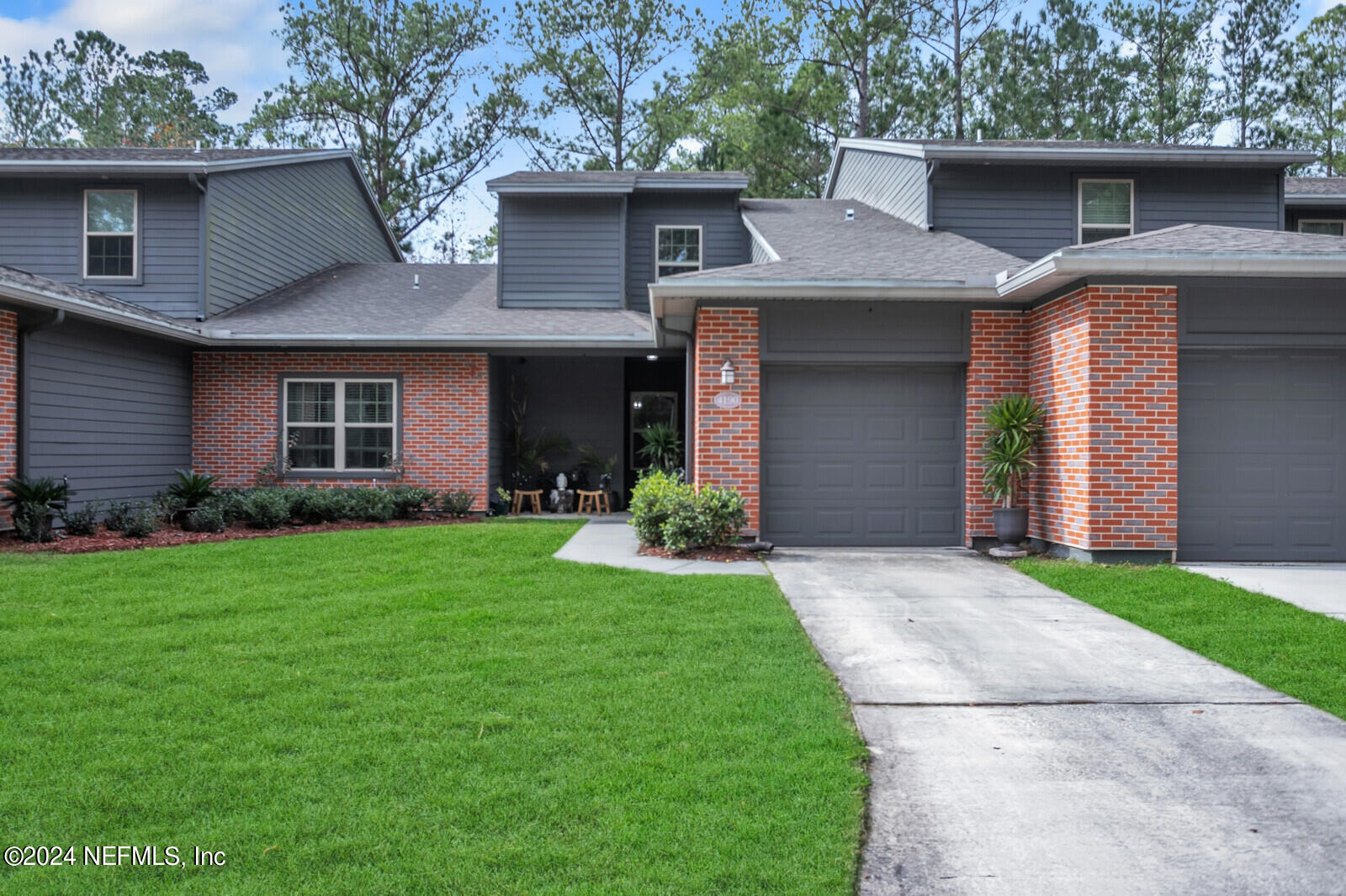 4190 Quiet Crk Loop Middleburg, FL 32068 - Photo 2 of 22 a front view of a house with a garden and yard