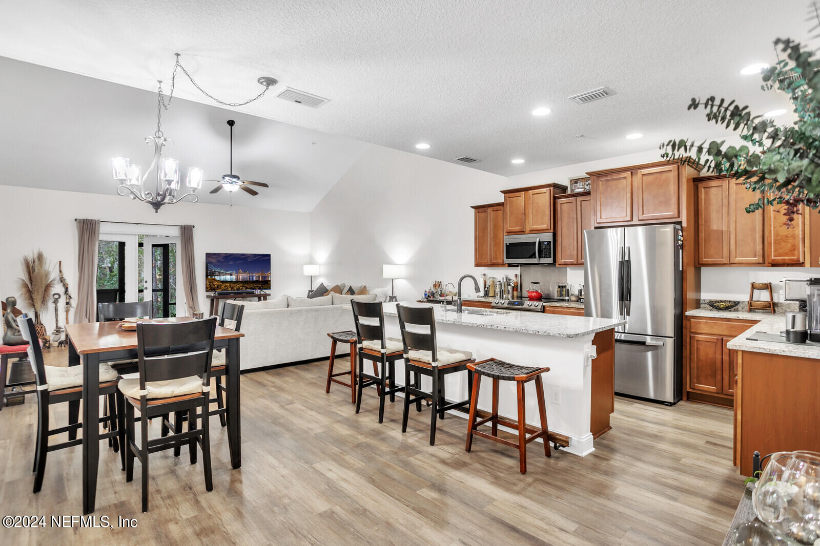 4190 Quiet Crk Loop Middleburg, FL 32068 - Photo 4 of 22 a kitchen with refrigerator a dining table and chairs