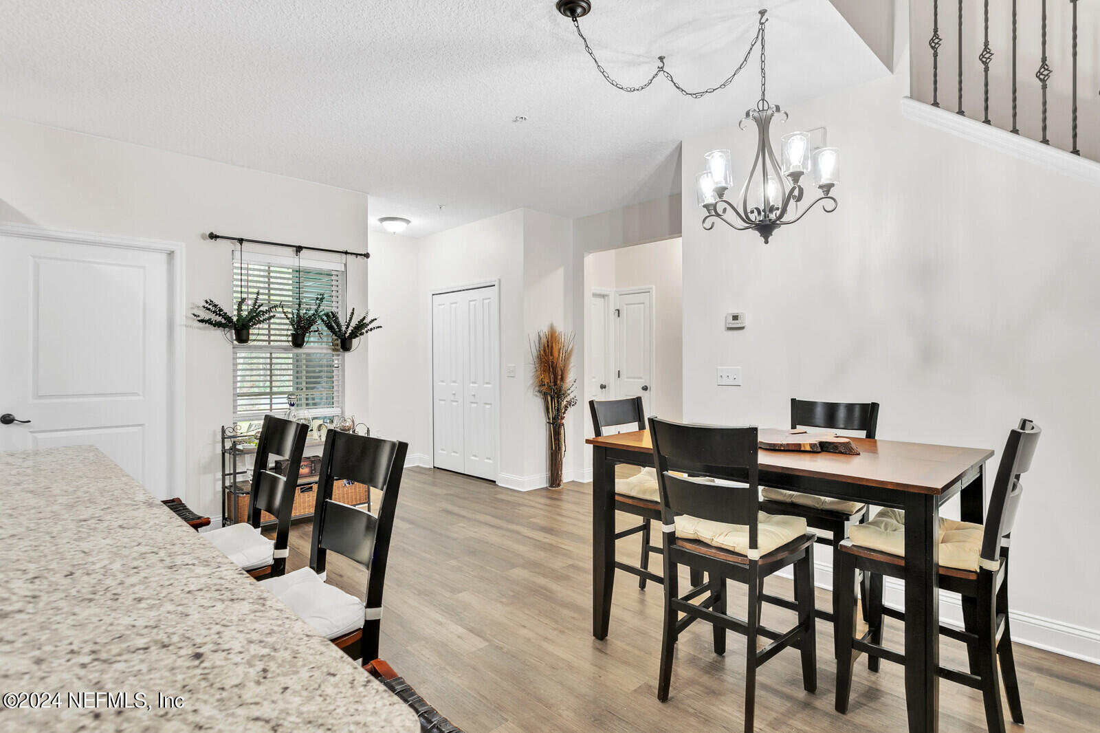 4190 Quiet Crk Loop Middleburg, FL 32068 - Photo 10 of 22 a view of a dining room with furniture a chandelier and wooden floor