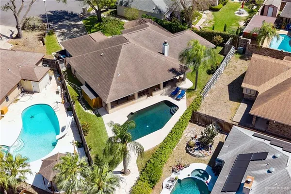 an aerial view of a house with a yard and garden