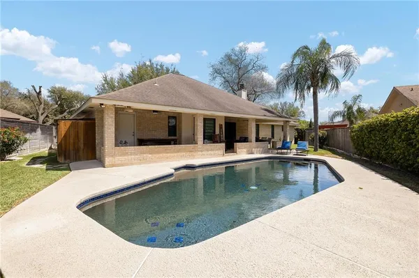 a view of a house with swimming pool and porch
