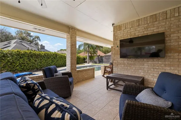 a living room with fireplace furniture and a flat screen tv